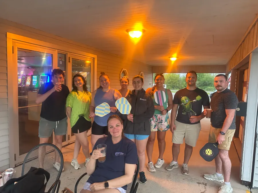 A pickleball group with paddles after open play at Backyard Brew